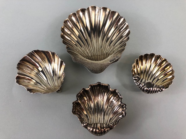 Collection of four Hallmarked English silver shell designed salts, the largest 10 x 8cm and total