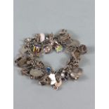 Silver 925 charm bracelet with approximately 42 charms, some of unusual design, London taxi ,