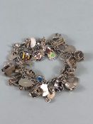 Silver 925 charm bracelet with approximately 42 charms, some of unusual design, London taxi ,