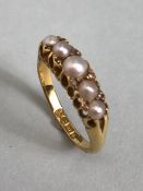 18ct Gold ring set with five graduated pearls and divided by pairs of small diamonds size approx 'M'