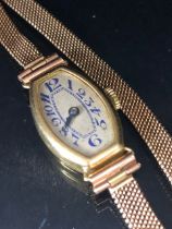 18ct ladies dress watch early 20th century, rounded lozenge shape with Arabic numerals on 9ct mesh