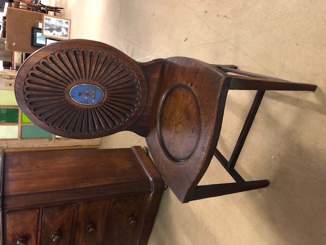 Early 19th century mahogany hall chair with oval rosette back with painted Armorial, scoop seat on