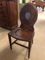 Early 19th century mahogany hall chair with oval rosette back with painted Armorial, scoop seat on