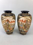 Japanese pottery, a pair of Satsuma vases hand decorated with courtesans in gardens Cobalt blue with