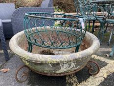 Two circular garden planters, one with open wirework, the other a large concrete dish on stand,