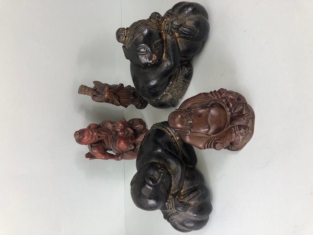 Oriental wooden carvings, to include Two Immortals a seated old man and a pair of children decorated