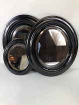 Three Similar Oval Antique Black lacquered mirrors the largest approx 38cm tall