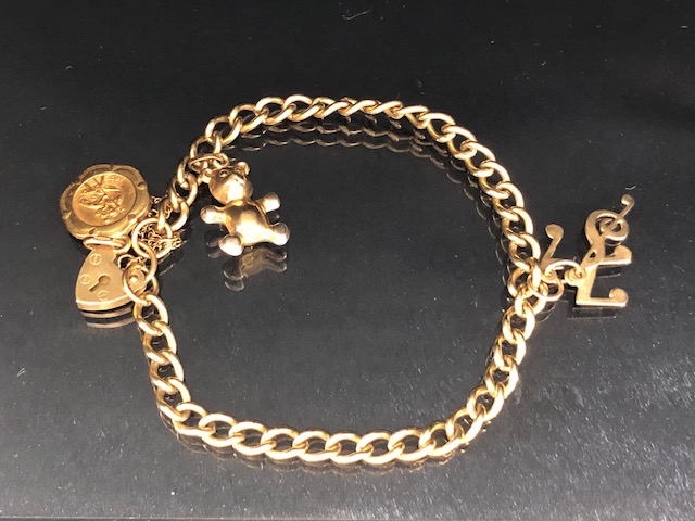 9ct Gold bracelet with 9ct Gold heart shaped lock and 9ct St Christopher and musical notes total