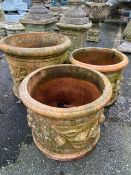 Three similar large terracotta planters