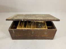 Vintage wooden tool chest containing various tools including planes, chisels etc