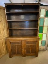 Arts and Crafts oak dresser with shelves above and two cupboards under by maker Curtiss & Sons,