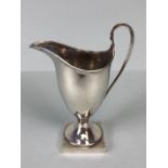 Silver Hallmarked jug on square base looping handle and fluted spout and rim, hallmarked for Chester