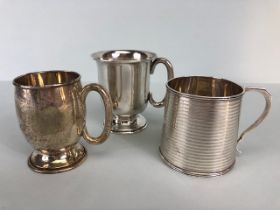 Three hallmarked silver hallmarked small cups each with a handle and two on pedestal bases the