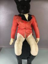 Advertising Interest, Black plush seated figure of a fox dressed in hunting pinks, used in country