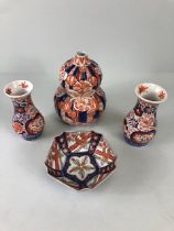 Oriental ceramics, a pair of Japanese Imari vases decorated in blue and red with flowers, un-