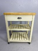 Modern kitchen island unit or butchers block with drawer and two shelves under and blockwork top, on