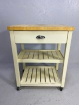 Modern kitchen island unit or butchers block with drawer and two shelves under and blockwork top, on