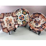 Oriental ceramics, three Japanese Imari chargers one with scallop edge and flower designs