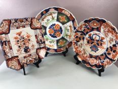 Oriental ceramics, three Japanese Imari chargers one with scallop edge and flower designs