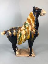 Oriental Ceramics, Chinese Tang Horse of usual form decorated in dark blue glaze with green and
