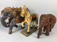 Oriental carved and decorated wooden horse and two elephants, the largest approximately 24 cm high