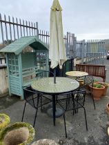 Circular garden tile top table, four chairs and a parasol