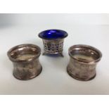 English hallmarked silver, two matching napkin rings with beaded edges and flower decoration and a