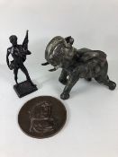 Bronze sculptured, Three patinated bronze ornaments, a charging bull elephant a classical male