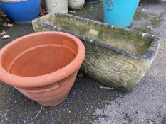 Concrete garden trough and a terracotta garden pot