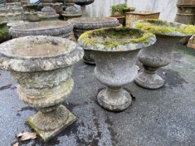Three concrete garden urn planters