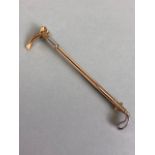 15ct Gold brooch in the form of a Horse riding Crop approx 60mm in length and total weight approx