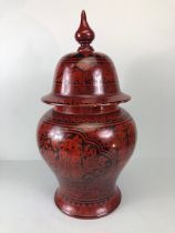 Oriental lacquer ware, Indonesian red and black lacquer lidded urn ,decorated with flowers