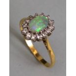 18ct Gold ring set with an oval Opal and surrounded by diamonds 'P'