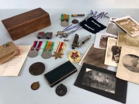 Military interest, collection of military, and civil medals badges, photos and associated items