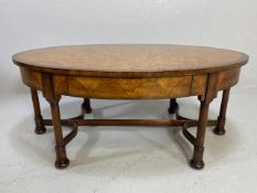 Oval coffee table on turned legs and bun feet with burr walnut top and frame inlay with two