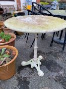Ornamental circular garden table on wrought iron base