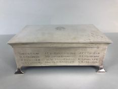 Large Silver hallmarked cigarette box on arrow feet, with cedar lining, crest to lid and names