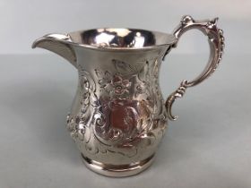 Victorian Silver Hallmarked Cream Jug Birmingham 1877, decorated with repousse flora and foliage and