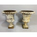 Pair of wrought iron painted and weathered urns, on square plinth base, of classic shape and form,