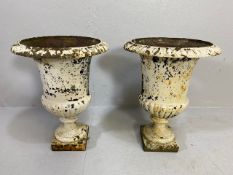 Pair of wrought iron painted and weathered urns, on square plinth base, of classic shape and form,