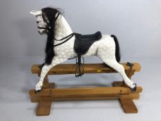Fine example of a dapple grey child's rocking horse with leather saddle and bridle, metal