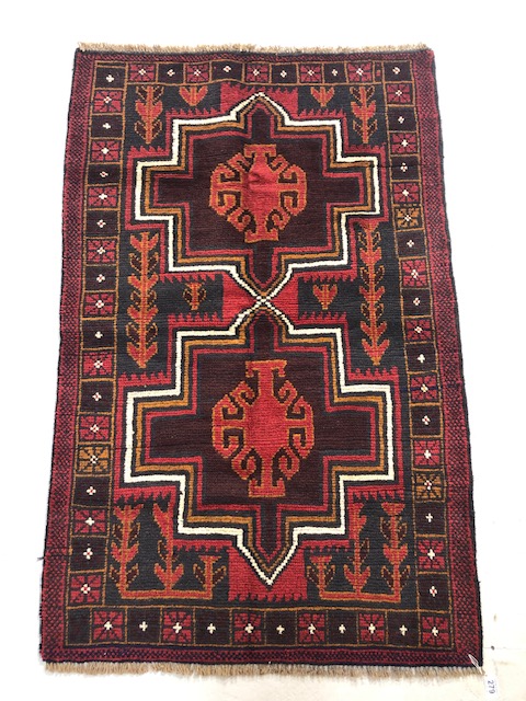 Oriental hand knotted wool carpet Baluchi geometric patterns on a dark burgundy background