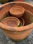 Collection of terracotta garden pots, one large, four small