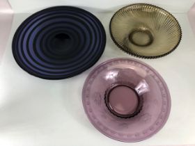 Decorative glass, three late 20th Century glass bowls two in purple one in smoked glass, largest