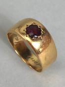 18ct Gold ring set with a red gemstone in a recessed star setting size approx 'L' and 6.5g