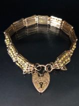 Unusual gate style bracelet in 9ct Gold with 9ct heart shaped lock the gate design of alternate bars