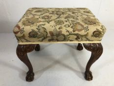 Antique furniture, padded foot stool on ball and claw legs upholstered in floral fabric