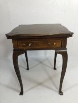 Edwardian games table with inlay top, on serpentine legs, the four triangular quarters of the top