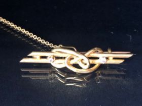 15ct Yellow Gold 19th Century bar brooch of knot design set with two diamonds with safety chain