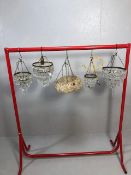 Vintage lighting, four small decorative chandeliers of varying sizes and styles along with a mid